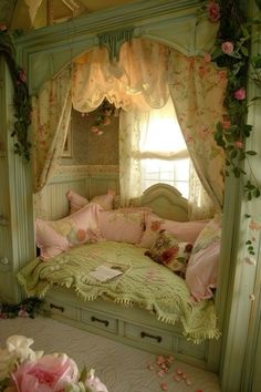 a canopy bed with pink flowers on it