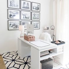 a white desk with lots of pictures on the wall