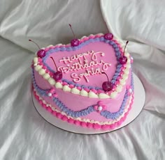 a pink heart shaped birthday cake on a white tablecloth with the words happy birthday my