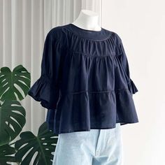 The sol blouse is a voluminous tiered top with a crew neck and delicate rows of sheer cotton lace trims. it has puffed sleeves with an elasticated ruched band that creates a frilled cuff at the elbow. unlined and slightly sheer.    made in india. 100% pima cotton lawn. this garment is oeko-tex® certified.    back lenght: 52 cm. (size xs on mannequin).    care: this item can be machine-washed at low temperature on delicate cycle with soft detergent and hung to dry.    merlette was founded in 2016 Puff Sleeve Peasant Top With Ruffles For Daywear, Spring Peasant Top With Ruffles For Gatherings, Cotton Ruffle Blouse For Gatherings, Cotton Peasant Top With Ruffles And Puff Sleeves, Cotton Peasant Top With Puff Sleeves And Ruffles, Billowy Peasant Top With Puff Sleeves And Ruffles, Cotton Puff Sleeve Top With Ruffles For Brunch, Studio Nicholson, Lace Trims