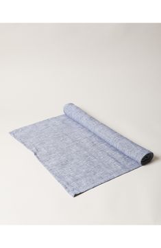 a roll of blue fabric on a white background