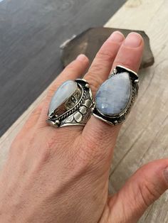 Powerful statement Moonstone rings made with alloy metal. As you can see in the pictures, each ring has a number for you to choose your favorite one, as each stone is unique. They are all size adjustable and unisex. Size 8 would be the smallest recommended and size 11.5- 12 would be the biggest size recommended. From ring 1 to ring 30, the dimension go between the bigger ring and the smaller one which you can see in the pictures with the blue meter. The ring number 31, which is the only one with Bohemian Metal Crystal Promise Ring, Bohemian Moonstone Ring With Large Stone, Bohemian Large Moonstone Ring, Adjustable Moon Shaped Bohemian Rings, Bohemian Moon Shaped Adjustable Rings, Bohemian Adjustable Moon-shaped Rings, Bohemian Moon Shaped Promise Ring, Bohemian Moon Shape Promise Ring, Silver Moon Shaped Bohemian Crystal Ring