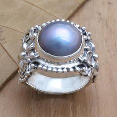 Dyed a gorgeous iridescent blue, the smooth pearl on Buana's cocktail ring glows beautifully. The Balinese artisan uses sterling silver to hand craft the ring, engraving the precious metal with traditional Balinese swirls. Centered by a cultured Mabe pearl, the ring is perfect for elegant occasions. Pearl Cocktail Ring, Ring Engraving, Silver Cocktail, Mabe Pearl, Iridescent Blue, Hand Craft, Precious Metal, Balinese, Pearl Color