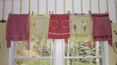 a kitchen window with red and white checkered curtains hanging from it's side