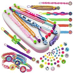 a bunch of bracelets that are laying on a table with beads and other items