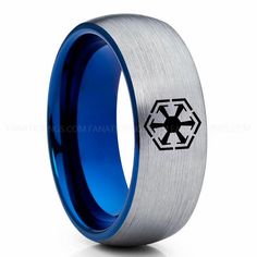 the star wars symbol is engraved on this blue and silver wedding ring, which features an inter