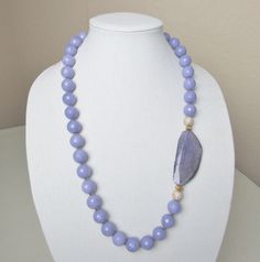 Single strand purple beads with large purple agate accented with pave beads Elegant Lavender Beaded Necklace With Natural Stones, Elegant Purple Necklace With Large Beads, Elegant Lavender Beaded Necklace With Gemstones, Elegant Purple Agate Beaded Necklaces, Elegant Purple Agate Beaded Necklace, Purple Agate Gemstone Beaded Necklace, Elegant Large Purple Beads, Elegant Purple Faceted Beads, Elegant Lavender Beaded Necklace With Polished Beads