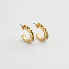 Elevate your style with these charming gold hoops adorned with hand-painted enamel delicate pink flowers. These earrings celebrate the fleeting beauty of spring, a perpetual bloom captured in a timeless design. Key features: Hand-painted enamel Hand-carved detailing 18K Worn-gold plated zinc alloy, enamel 5mm width band; 2mm thick-rounded; 16mm internal diameter Comes in a gift box with cotton pouch Spring Yellow Gold Earrings Gift, Yellow Gold Earrings For Spring Gift, Spring Gift Yellow Gold Earrings, Spring Flower Enamel Earrings, Spring Hand Painted Jewelry, Hand Painted Jewelry For Spring, Hand Painted Jewelry As Spring Gift, Hand Painted Jewelry For Spring Gift, Small Hoop Jewelry For Spring Gift