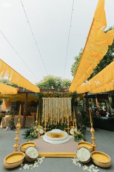 an outdoor ceremony with yellow and white decorations