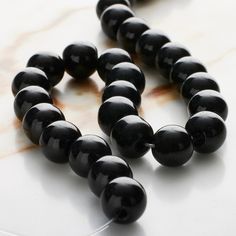 the beads are black and shiny on the surface