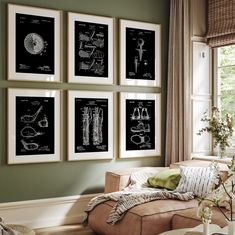 a living room filled with furniture and framed pictures on the wall above a couch in front of a window