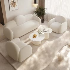 a living room filled with white furniture next to a window