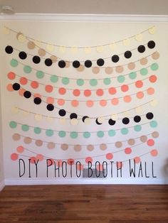 a diy photo booth wall is decorated with polka dots