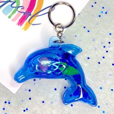 a blue dolphin keychain sitting on top of a table