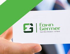 a person holding up a business card with the name fawn germer on it