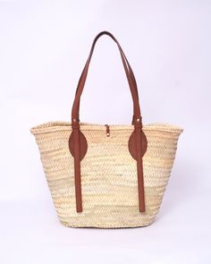 Do you want to look stylish and hippy? Get your hands on this handmade straw bag. It's high quality, eco-friendly, and handcrafted by women in Morocco. Its design is unique and timeless. Get yours now! we are proud to introduce our signature straw french bag to you. it is handmade by our talented artisan who has been working with us for years. this beautiful bag has a unique design that you would find nowhere else. the light and durable material are ideal for taking the bag on your adventures. Style is an important part of your life. The straw bag is a great way to spice up your look. You can either choose from our pre-made designs or customize the bag to your liking. Item's details: *Handmade in Morocco *Material: 100% Woven natural palm straw *Trim: 100% Vegan Leather Dimensions : Height Eco-friendly Woven Leather Beach Bag, Natural Palm Leaf Beach Bag For Travel, Eco-friendly Beach Bag With Woven Leather And Natural Fiber, Spring Beach Bag In Natural Woven Leather, Eco-friendly Beach Bag With Woven Leather, Eco-friendly Beige Woven Leather Beach Bag, Spring Natural Woven Leather Beach Bag, Spring Season Natural Woven Leather Beach Bag, Bohemian Straw Bag With Woven Leather In Natural Color