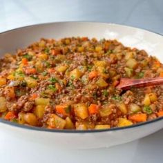 a white bowl filled with food on top of a table