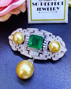 SPECTACULAR! ONE OF A KIND, ART DECO, HANDCRAFTED 18K WHITE GOLD PENDANT/BROOCH, FEATURING AN ENORMOUS 11.32 CARATS ZAMBIAN, CLASSIC EMERALD-CUT EMERALD AND TOP GRADE, SPARKLING, NATURAL, UNTREATED DIAMONDS! WITH HUGE 15 mm GOLDEN SOUTH SEA PEARL & 2 pieces of 12 mm Golden South Sea Pearls! Set in 18K solid white gold brooch! EMERALD: Weight: 11.32 carats! Vivid sweet green, with great transparency. SI1 clarity emerald. Few internal imperfections, visible but not noticeable when worn. Natura Emerald Brooch, Necklace Art Deco, Emerald Style, White Gold Earrings Studs, Golden South Sea Pearls, Pendant Brooch, White Gold Pendant, Art Deco Pendant, Gold Brooch