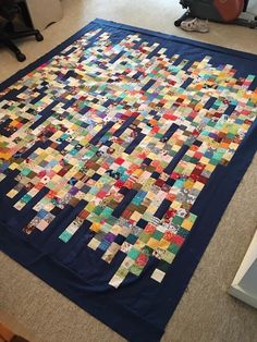 a large quilt is laying on the floor