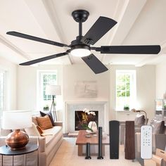 a living room with white walls and ceiling fans