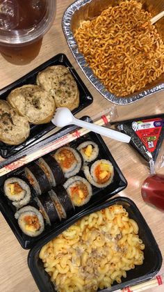 several trays of food on a table with chopsticks