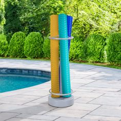 two blue and yellow tubes next to a swimming pool