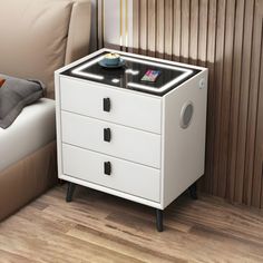 a white night stand with two drawers on it