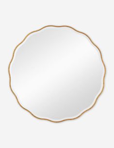 a round white mirror with gold trim around the edges and an oval frame on top