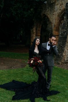 a man and woman dressed in gothic clothing