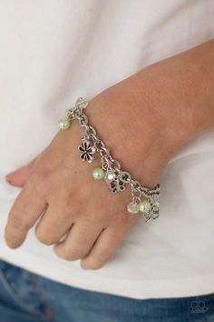 Infused with Green Ash pearls and iridescent crystal-like beads, mismatched silver charms, including a clover, butterfly, heart, and floral frames, swing from a chunky silver chain around the wrist. Features an adjustable clasp closure. Sold as one individual bracelet.