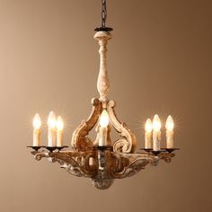 a chandelier with five lit candles hanging from it