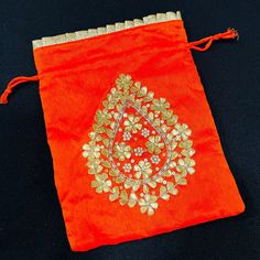 "Jaipuri Gota Patti Potli Bag/ Designer Embroidered Potli/ Wedding Bags For Women/ Embroidered Purse/ Potli Bag/ Gota work Wedding Bag Description: Made in Colorful Leheriya Cloth with Golden Hand Embroidery with Gota Patti Size -: Length- 8\" , width- 6\" Material -: Shimmer Cotton, Gota Patti, Beads Best Gift item for Mehendi/ Mayun/ Haldi/Wedding Function. Used to carry earrings, rings, bracelets, and other jewelry items.  Other usages as storage for necklaces, bangles, and other accessories Red Embroidered Potli Bag For Party, Festive Orange Embroidered Fabric For Wedding, Festive Multicolor Embroidered Handwork Potli Bag, Festive Multicolor Embroidered Potli Bag With Handwork, Elegant Dori Work Dupatta For Puja, Traditional Gold Pouch For Festive Season, Festive Multicolor Embroidered Handwork Clutch, Traditional Embroidered Clutch For Festivals, Elegant Dupatta With Dori Work For Puja