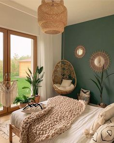 a bed room with a neatly made bed and a hanging chair next to a window