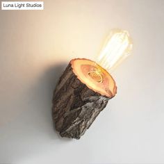 a light that is on top of a piece of wood with a bulb in it