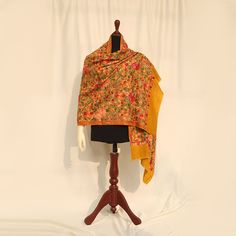 Mustard high-quality embroidered Kashmiri pashmina kashmiri wool shawl embellished with Kashmiri aari multicolored embroidery all over the piece. Perfect for formal occasions to add a pop of color to your outfits. These medium-length shawls are the perfect length to be styled with both eastern and western outfits. Dazzle up your wardrobe with a uniquely crafted fully embroidery shawl. Product specifications: Base color: Mustard Material: 100% Pashmina wool Washing instructions: Hand wash in cold water Dimensions:200cm by 70cm Shipping details: The product will be delivered to you between 5-10 working days. 1-2 days processing time for all orders. Now offering free shipping to your doorstep! Traditional Jamawar Dupatta With Naqshi Embroidery, Traditional Jamawar Dupatta With Naqshi Details, Traditional Jamawar Dupatta With Naqshi, Multicolor Unstitched Wedding Suit With Naqshi, Multicolor Naqshi Unstitched Suit For Weddings, Transitional Semi-stitched Dupatta With Naqshi, Transitional Semi-stitched Naqshi Dupatta, Traditional Naqshi Dupatta, Eid Jamawar Dupatta With Naqshi Detailing