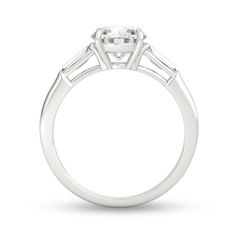 a white gold engagement ring with three baguets