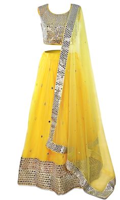 The skirt is is paired with a matching blouse and net dupatta and yellow lehenga! Yellow Floor-length Sharara With Sheer Dupatta, Yellow Choli With Sheer Dupatta For Navratri, Fitted Bollywood Skirt With Mirror Work, Bollywood Style Fitted Skirt With Mirror Work, Navratri Wedding Skirt With Mirror Work, Festive Yellow Choli With Cutdana, Festive Yellow Choli With Sheer Dupatta, Festive Yellow Choli With Cutdana Details, Yellow Floor-length Party Sets