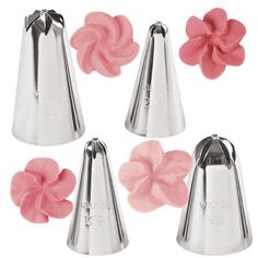 four metal bells with pink flowers on the top and one has a flower in the middle