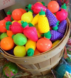 a basket filled with lots of colorful plastic fruit