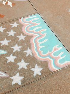 a skateboarder is riding down the sidewalk in front of stars and swirls