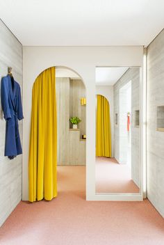 a hallway with yellow curtains and pink carpet