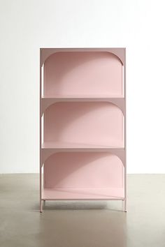 a pink shelf sitting on top of a cement floor