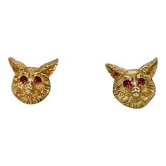 This is part of Chairish’s Fine Jewelry assortment.  A distinguished pair of vintage 14K gold post earrings, crafted in the likeness of fox heads. Each earring features prong-set, faceted ruby eyes. One earring bears the hallmark of J.E. Caldwell & Co. and 14K, while the other lacks a mark. It is likely that they were originally part of a stud set, given the slight differences between the heads. However, once worn, these differences are indiscernible. The condition is excellent.  Dimensions: Width: 1/2", Length: 3/8", Weight: 4.7 grams. Gold Fox, Fox Head, Earring Jackets, Stud Set, Prong Setting, Post Earrings, Hallmark, Bears, Ruby