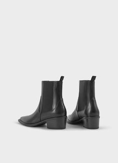 Kelsey is the minimalistic Chelsea boots with a western-inspired design. The style is crafted from black leather and features a pointed-toe shape, elastic side panels and pull-on tabs. The sleek block heels measure 40mm. Black leather Pointed-toe shape Elastic side panels 40mm heels Pull-on tabs For long-lasting care: use a black shoe cream and protector spray to ensure a longer lifespan. Shaft height: 168 mm Shaft width: 126 mm Heel height: 40 mm (based on size 37) Article no.: 5810-201-20 Black Chelsea Boots With Sculpted Heel, Modern Black Chelsea Boots With Block Heel, Black Chelsea Boots With Sculpted Heel For Work, Modern Chelsea Boots With Stacked Heel For Work, Modern Chelsea Boots With Sculpted Heel For Work, Black Chelsea Boots With Sculpted Heel And Pointed Toe, Clogs Heels, Black Shoe, Cream Shoes