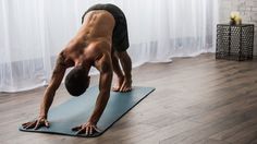 a man standing on one leg and doing a handstand in front of a window