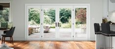 an open kitchen and dining room with sliding glass doors