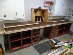 a workbench in a garage with lots of cabinets