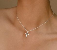 A timeless symbol of faith and elegance. Crafted with meticulous attention to detail, this pendant features a sleek and polished sterling silver cross suspended from a silver chain. Whether worn as a personal statement of belief or as a stylish accent to your everyday attire, this necklace is sure to become a cherished piece in your collection. Elevate your look and express your faith with grace and sophistication. Product Type Cross Pendant Necklace Material 925 Sterling Silver Color Silver Fea Elegant Silver Cross Necklace, Elegant Necklace With Silver Chain And Cross Pendant, Elegant Cross Pendant Necklace With Silver Chain, Elegant Sterling Silver Cross Necklace As Gift, Elegant Silver Chain Cross Necklace, Sterling Silver Clavicle Chain Cross Necklace, Elegant Silver Crucifix Necklace, Sterling Silver Cross Necklace With Clavicle Chain, Elegant Silver Necklace With Cross Pendant