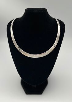 Stunning hammered effect vintage sterling silver COLLAR CHOKER  necklace.  The neckline of this necklace sits just under the neck above the collar bone and is very elegant and striking. The necklace is made of solid silver ( stamped 925).  This necklace would make an ideal gift for someone who enjoys simple timeless classic jewellery? Description - Internal Diameter- 11.5 cm  Fits most medium and small sized necks. Box for presentation only and not included in the purchase.  All items are packed safely packed in bubble wrap, brown craft paper and packed in boxes with extra protection compostable packing pellets.. All items are sent by registered, tracked delivery. Thanks for looking Hammered White Gold Necklaces For Anniversary, Classic Hammered White Gold Jewelry, White Gold Hammered Necklace For Anniversary, Classic Sterling Silver Herringbone Necklace As Gift, Hammered Sterling Silver Necklaces In Silver, Formal Hammered Sterling Silver Jewelry, Silver Necklace With Shiny Finish For Anniversary, Anniversary Silver Necklace With Shiny Finish, Hammered Sterling Silver Necklaces For Anniversary