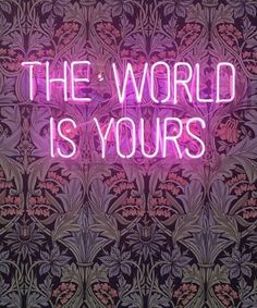 a neon sign that says the world is yours